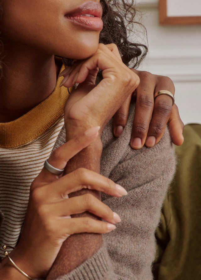 Two people embracing while wearing Oura Ring 5